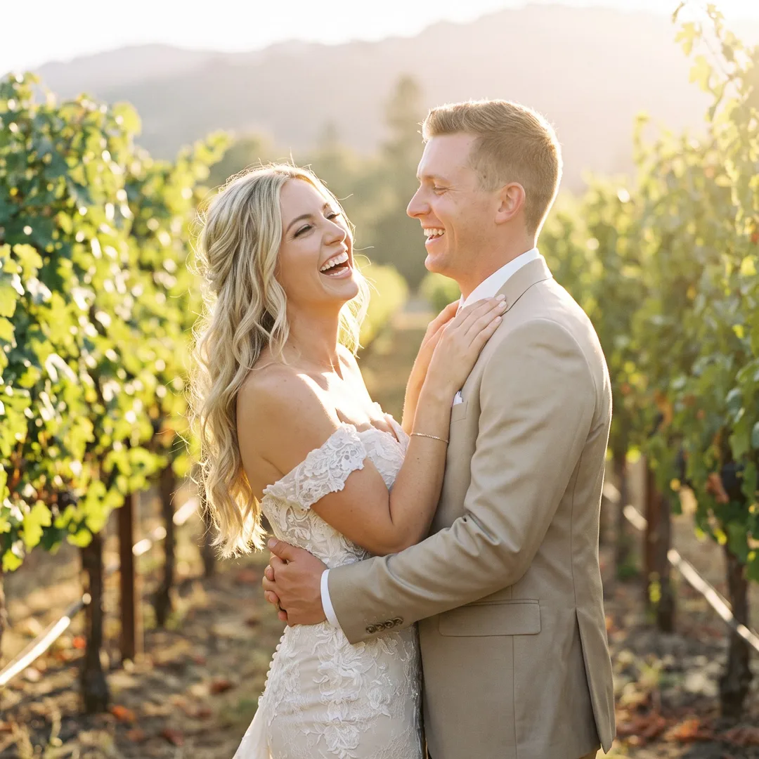 AI-generated wedding photo example: bride and groom laughing between vineyard rows at golden hour